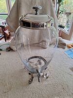 Complete glass beverage dispenser assembled on metal stand