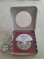 Open box showing pizza cutter inside with guard and blade