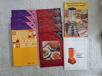 All nine recipe booklets laid out showing front covers