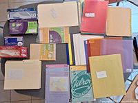 Overview of envelopes, folders, document sleeves and paper goods on tabletop