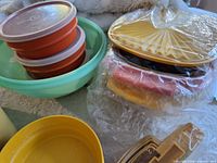 stacked small bowls with lids, large mixing bowl, packaged yellow colander set