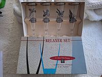 Open box showing four decorated glasses and box graphics