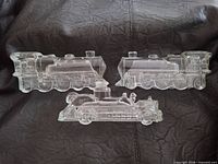 Front view of two locomotive and one fire truck clear glass candy containers