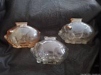 Three glass piggy banks front view