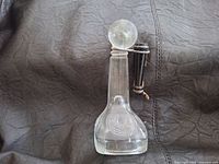 Front view of clear glass telephone candy container showing overall shape and attached receiver