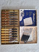 Open view of both Dinkee boxes showing 12 spreader knives and 6 cocktail forks