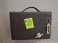 Side view showing textured body, shutter lever, winding knob, small viewfinder window