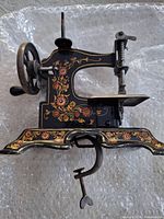 left side view showing floral decorations, hand crank wheel and clamp attached
