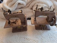 Front and side view of both Singer toy sewing machines