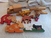 All items grouped: truck, trailer, cannon, four puzzles, three tops
