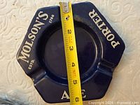 Blue Molson’s Porter Ale metal ashtray with measuring tape for scale
