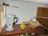 All three art glass items on shelf