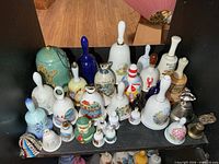 Overall view of upper shelf showing majority of bell collection