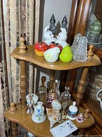 Top shelf contents: rabbit shakers, fruit and bird shakers, three clear glass cone shakers
