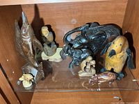 group of carved figures on shelf