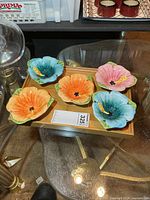 Top view of all five ceramic flower dishes on tray