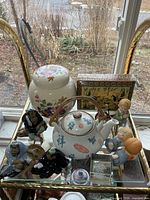 Top view showing ginger jar, teapot, decorative box and figurines
