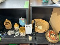 Overall view showing mini crocks, globe coin bank, wooden dishes, figurine and lidded dish