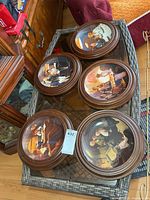 Top view of all five framed plates on glass table