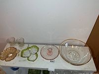 All six glass items on shelf