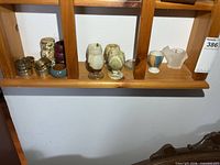 Shelf with napkin rings, marble egg cups, glass and porcelain egg cups
