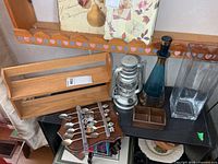 Overall lot showing spice rack, lantern, decanter, vase, spoon rack with spoons, wood tray