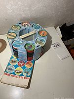 Holder with coins and booklet on table