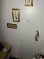 Four pictures hanging on wall showing relative sizes and arrangement