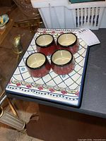 Overall lot showing 4 cups on patterned tray