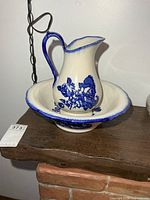 Pitcher inside bowl on shelf