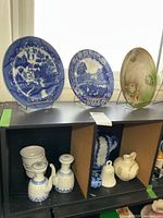 Overall view showing three plates, ramekins, pair of teapots, blue-white bell and horse decanter