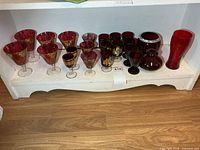 Entire bottom shelf showing all red glass items
