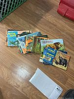 Stack of vintage Red Rose Tea card albums on floor