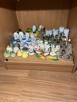 Wide view of entire shelf showing full assortment of shakers