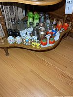 Full view of bottom shelf showing entire collection of assorted shakers