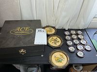 Closed ACE Gift Collection case, auction tag, three octagonal bird hanging plates and group of miniature bird plates