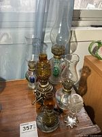 Group shot showing all six oil lamps on table