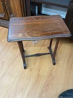 Full view of solid wood side table, showing top and legs