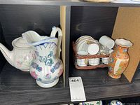 overall view of pitcher, teapot, cups in basket, vase