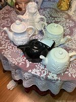 Group view of all five teapots on table