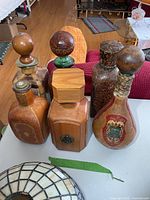 All six leather-wrapped bottles displayed on table
