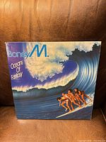 Front cover showing title, artist, wave artwork, owner inscription