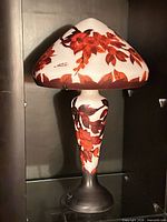 Full view of glass table lamp with floral overlay showing overall form