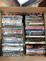 Open box showing two stacks of DVD and Blu-ray cases