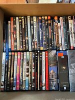 Top-down view of full carton showing two rows of DVD/Blu-ray spines