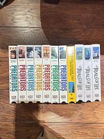 Twelve VHS tapes standing spine-out showing titles