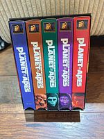 Spines of five VHS tapes in slipcase showing titles and condition