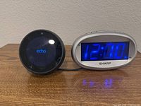 Amazon Echo Spot and Sharp alarm clock on tabletop