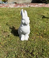 Front view of concrete bunny statue showing full form and surface finish