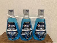 Front view of three sealed Crest Pro-Health Advanced Complete Care mouthwash bottles